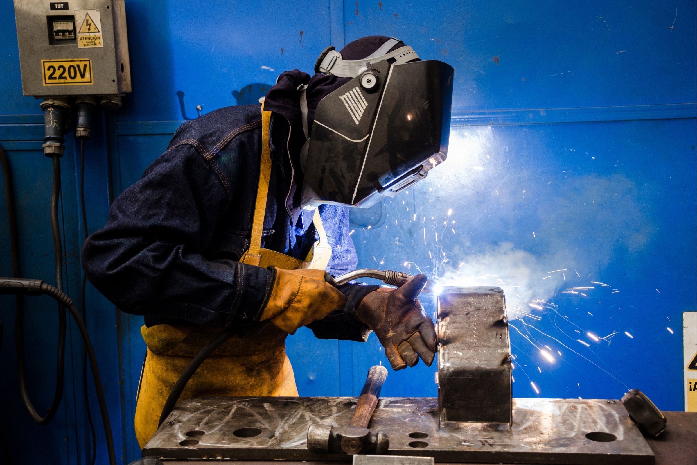 wearing protective eye wear and protective gloves while welding 